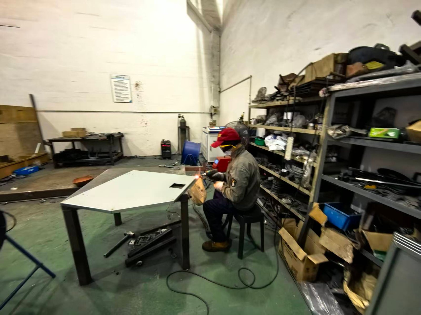 Technician welding a mobile light tower enclosure panel